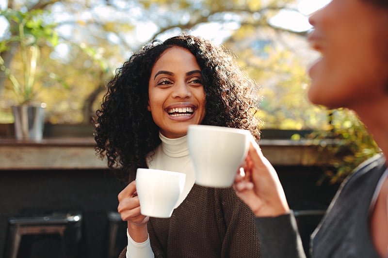 Two women enjoy some coffee after receiving excellent emergency care.